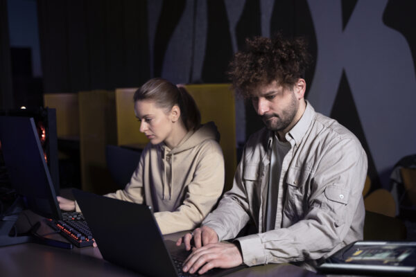 Two employees checking at the laptop and computer, Authorized Check Point training