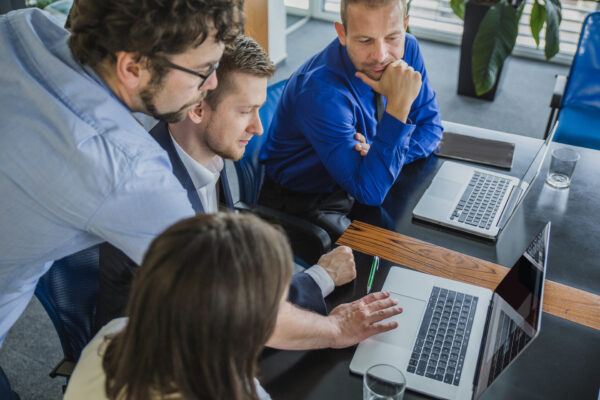 Four employees look at the laptop, Authorized Training Provider