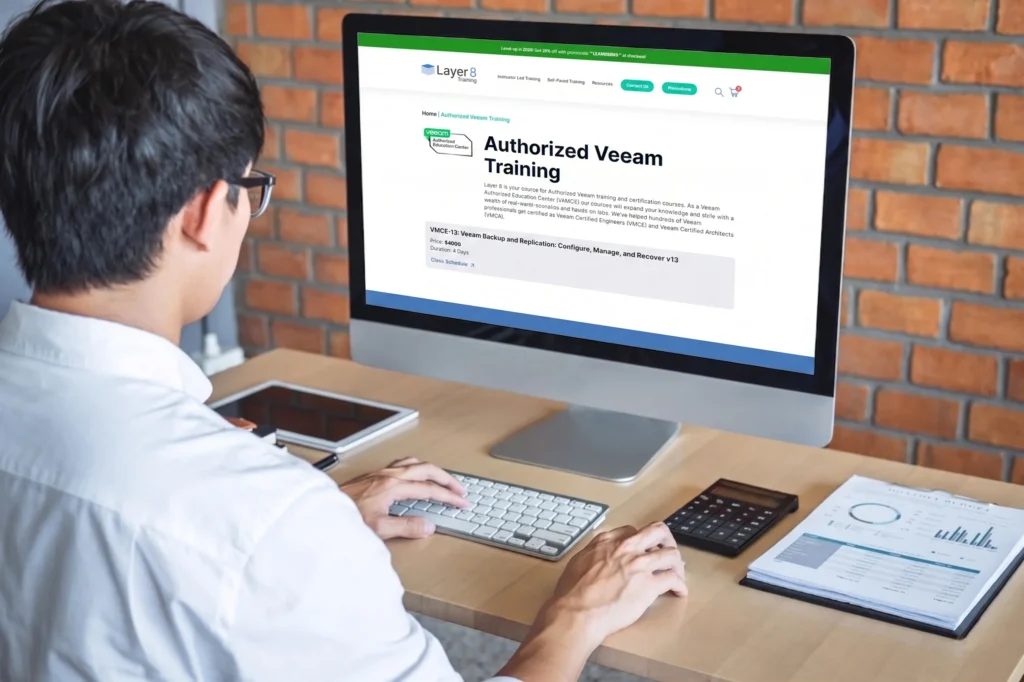 IT professional browsing the Layer 8 Training authorized Veeam training course page on a desktop computer, Veeam online training.